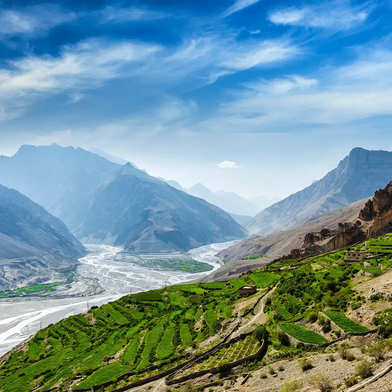 Landscape image of mountains on a sunny day with white clouds